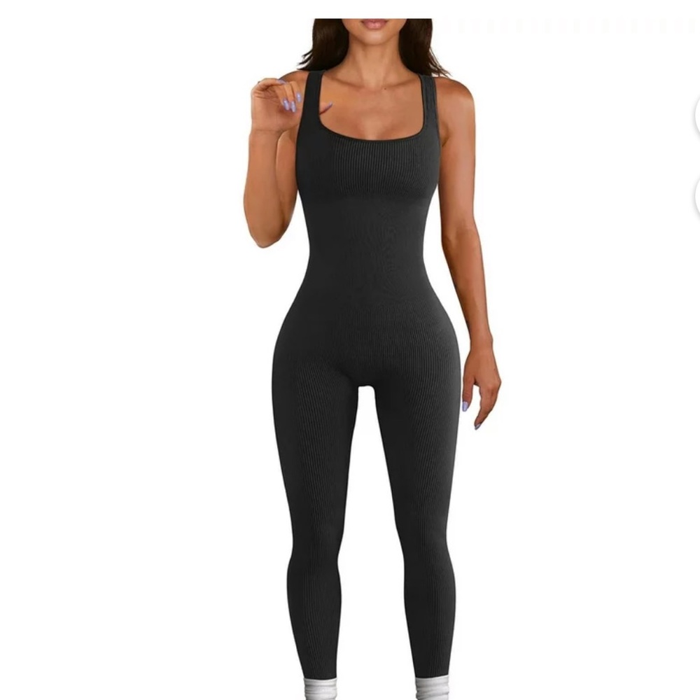 Anwnd black, ribbed, seamless unitard with adjustable straps.